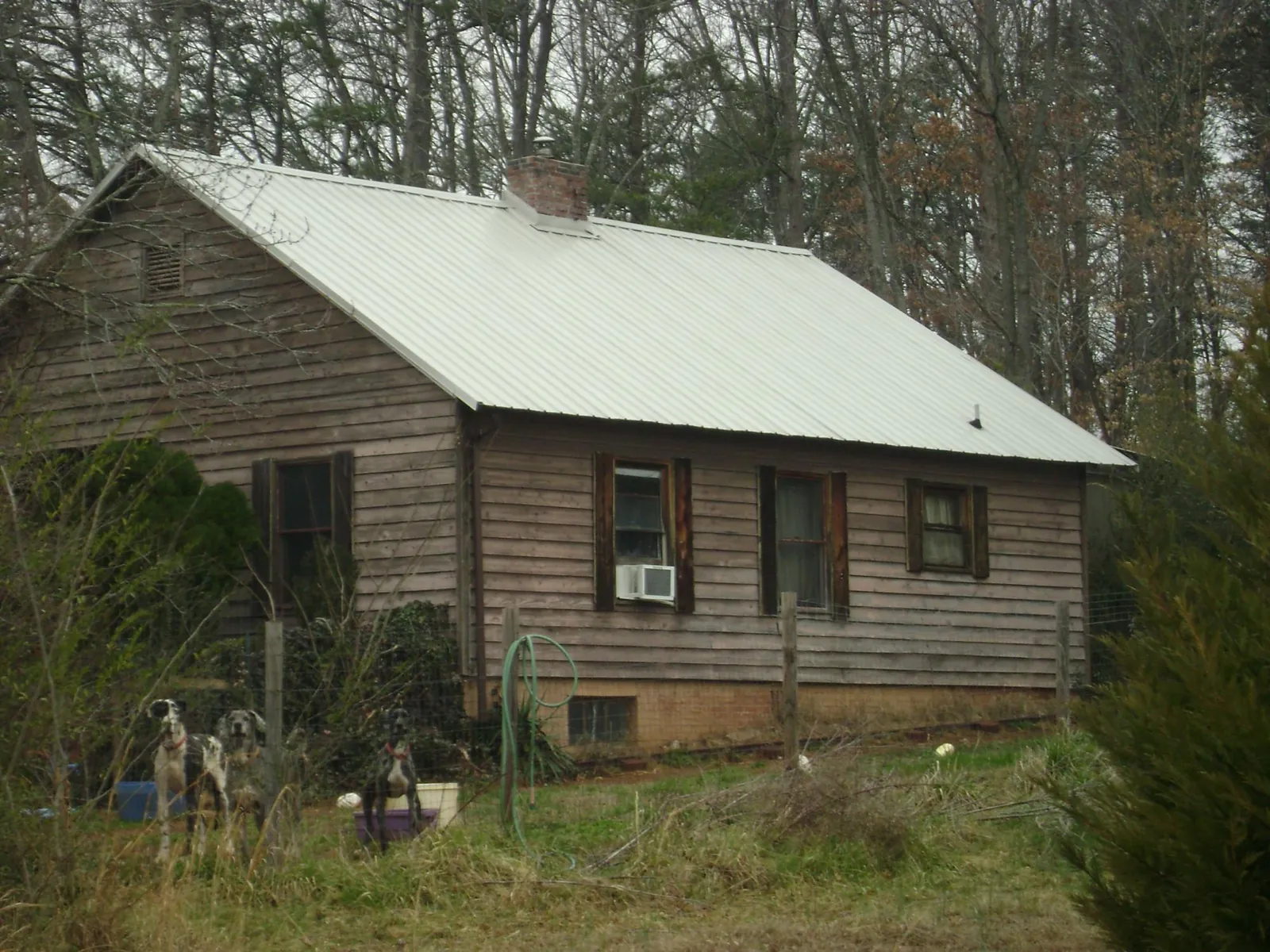 White metal roof on an old wood sided farmhouse, from a Metal Roof Installation job in Demotte